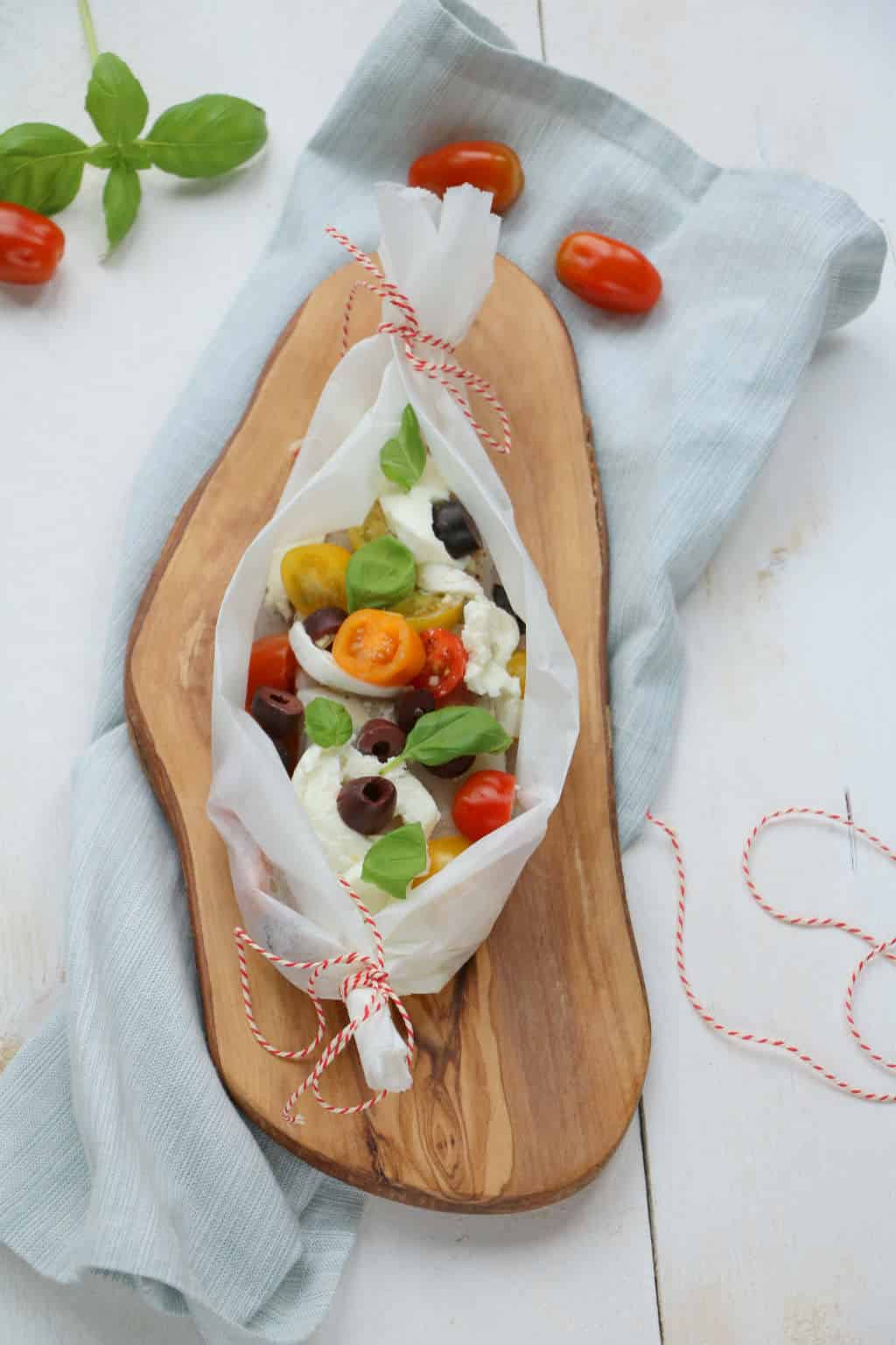 Met de kabeljauw uit de oven Jamie Oliver style maak je heerlijke vispakketjes met tomaat, mozzarella en olijven die je kunt aanpassen per persoon.